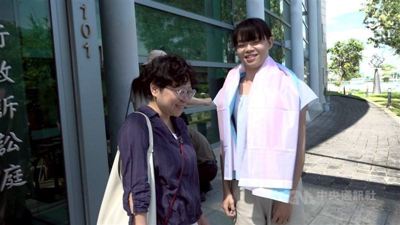 Transgender woman Vivi (right) and Chien Chih-chieh, the secretary-general of the Taiwan Alliance to Promote Civil Partnership Rights chat in front of the Taipei High Administrative Court in July 2024. CNA file photo