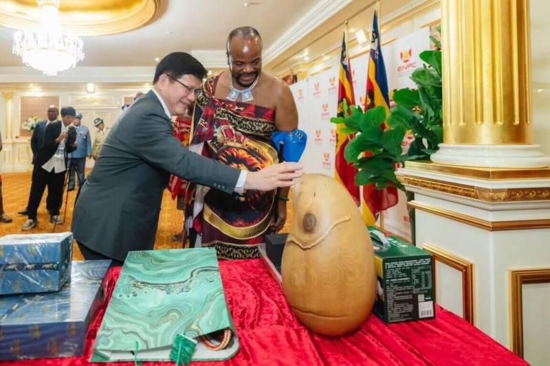外交部長林佳龍（左）以總統特使身份出訪史瓦帝尼，23日下午晉見國王恩史瓦帝三世（King Mswati III，右）時，代表台灣致贈藝術家康木祥的木雕作品「無限智」，以作為生日賀禮。（外交部提供）