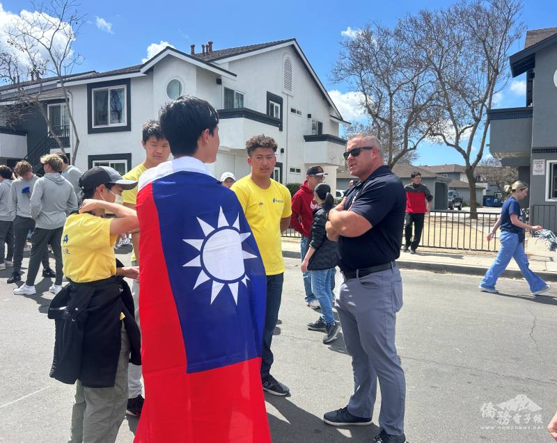 FASCA-SD member Christopher Pai (wearing Taiwan National flag) introducing FASCA and Taiwan to a spectator.