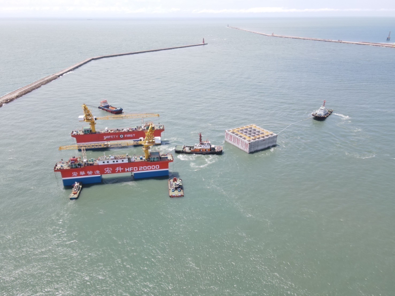 Caisson under tow to the installation zone after release from floating dock