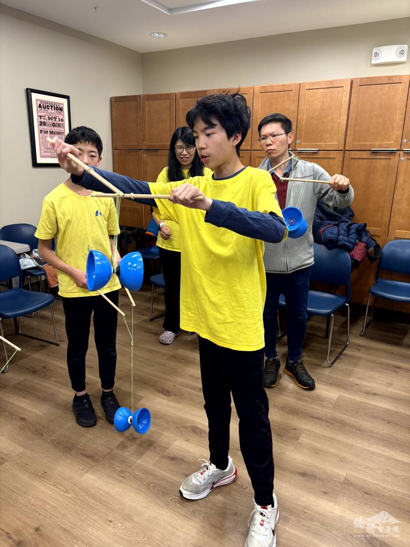 The instructor, Cile Lee, demonstrates how to perform the Monkey Somersault (猴子翻跟斗).