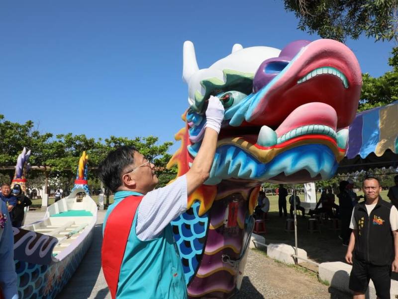 嘉義縣第39屆端午龍舟競賽31日將在東石漁人碼頭舉行，縣府與東石鄉公所15日率先舉辦龍舟開光點睛儀式，嘉義縣副縣長劉培東（前中）為龍舟點睛。（嘉義縣府提供）