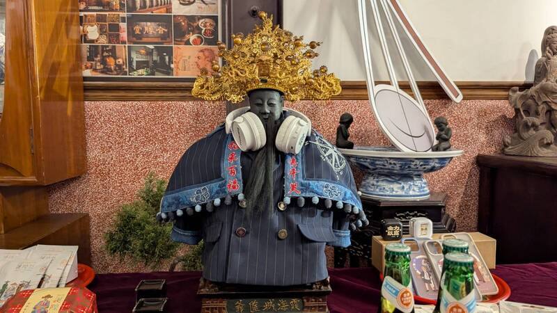 台北霞海城隍廟迎接渡台205年，廟方與大稻埕創意街區發展協會今年特別邀請設計師，為城隍爺打造一套「渡海軍官西裝」，肩頭上的耳機則象徵「上達天聽」。