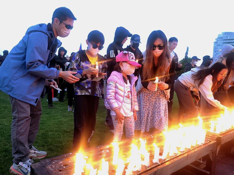 約千人聚集在溫哥華林思齊公園參與燭光晚會，不少家庭帶著孩子一起參加，象徵一代代傳承六四精神