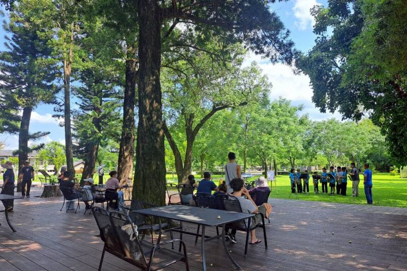 台南山上花園水道博物館將廣場空間綠美化，打造林蔭涼道，15日邀請山上國小薩克斯風樂團前往演出，吸引現場遊客駐足聆聽。（台南市文化局提供）