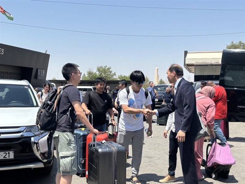 Taiwan's representative to Jordan Yang Syin-yi (in suit) greets Taiwanese nationals following their arrival in the Middle Eastern Kingdom Sunday. Photo courtesy of the Ministry of Foreign Affairs June 15, 2025