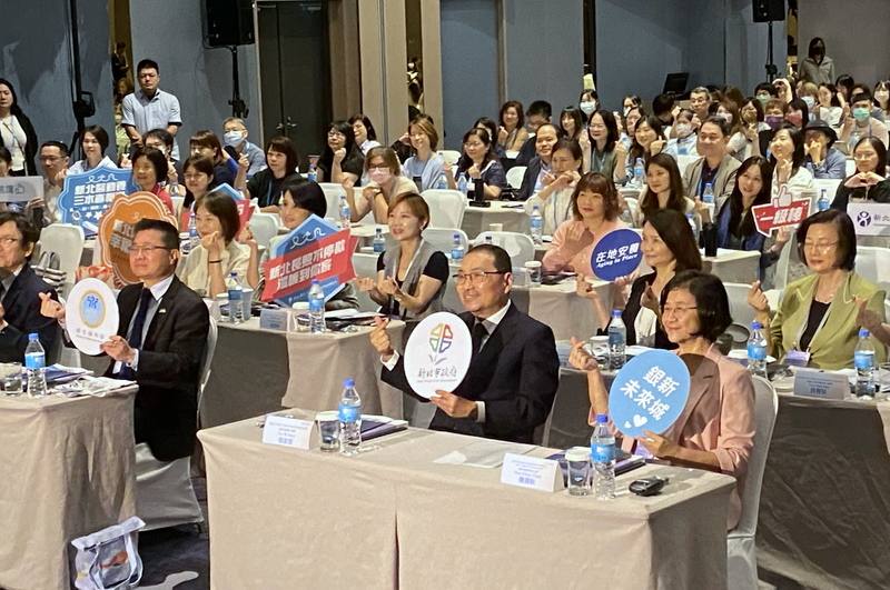 面對超高齡化社會的挑戰，新北市政府10日舉行2025長照創新國際研討會，衛福部次長呂建德（前右3）、新北市長侯友宜（前右2）等人與會，拿手舉牌合影留念。