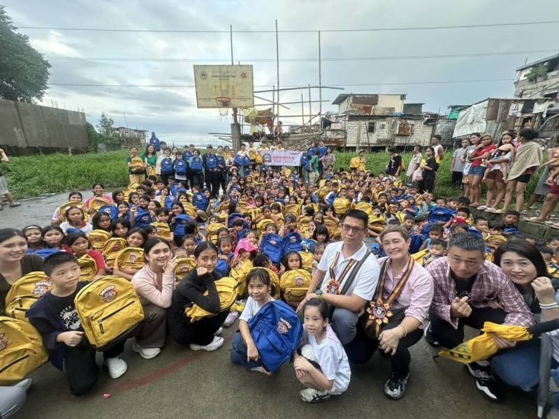 旅菲南線台商會與大都會國際兒童事工的志工一行近40人，12日在馬尼拉市以南大約30公里的水上貧窮社區，為當地孩童贈送300個新書包及學用品。（大都會國際兒童事工提供）
