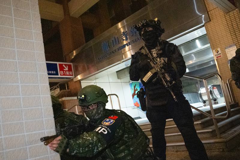 Two soldiers stand guard outside a MRT station in Taipei.