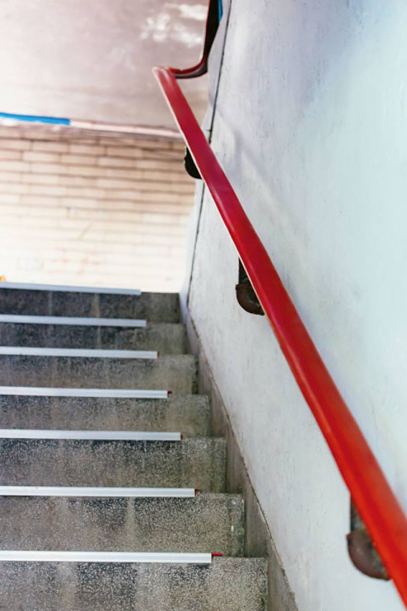 Offering good grip, the red plastic handrail covers are a classic feature of these old apartment buildings.