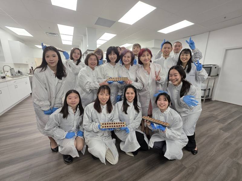 「台灣青年海外搭僑計畫」12名優秀年輕學子和大溫 哥華僑界代表參訪加拿大最大維生素軟糖製造商禾寶藍，開心展示親手製作的軟糖成品