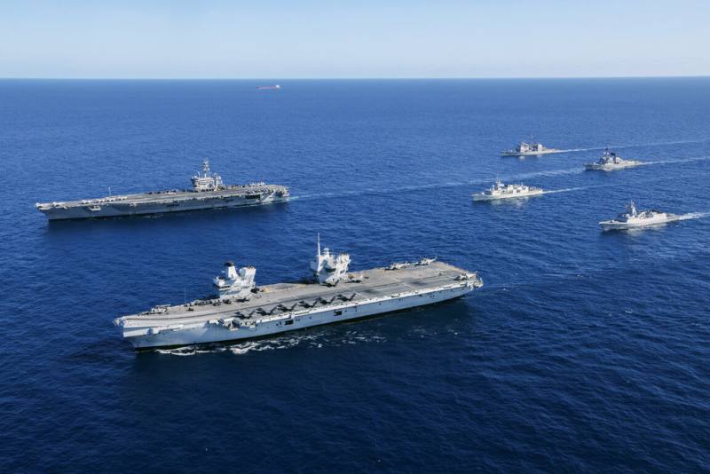 由英國「威爾斯親王號」（左前）和美國「喬治華盛頓號」（左後）航空母艦率領的打擊群，18日聯合澳洲、挪威、加拿大軍艦，在帝汶海展示「雙航艦」打擊群操演陣容，展現對印太區域的安全承諾