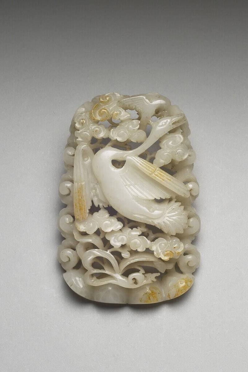 國立故宮博物院南部院區「人氣國寶展」即日起展出「忽必烈和他的時代」，圖為金至元代「春水」玉飾，以溫潤細膩的青白玉雕成，描繪春日蓮花叢中，海東青獵捕天鵝的瞬間。（故宮南院提供）