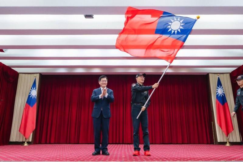 外交部長林佳龍（左）7月31日為參加「2025第30屆亞洲拉力賽」的台灣代表隊授旗，授旗予中華安駕學會理事長陳和皇（右）。（外交部提供）