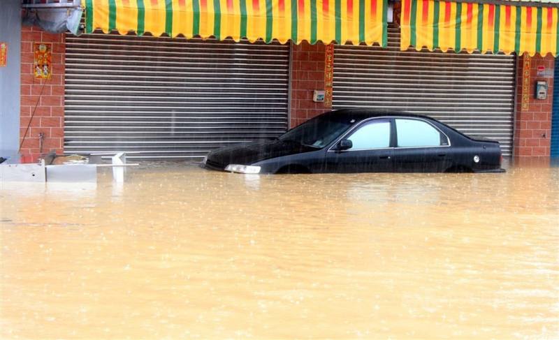 圖為暴雨過後，停放路邊的自小客車慘遭水淹。（中央社檔案照片）