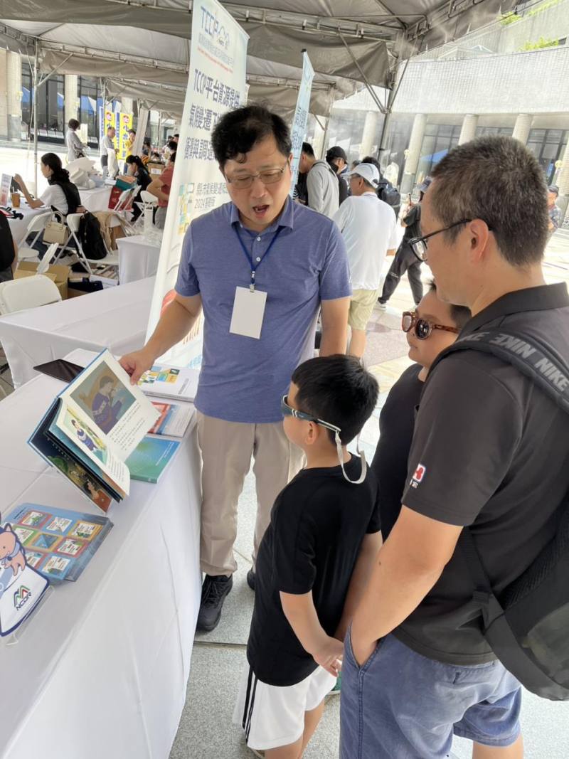 現場爸爸帶著小朋友參觀國家科學及技術委員會攤位