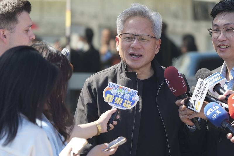 Nvidia CEO Jensen Huang talks to reporters at Taipei Songshan Airport in Taipei Friday. CNA photo Aug. 22, 2025