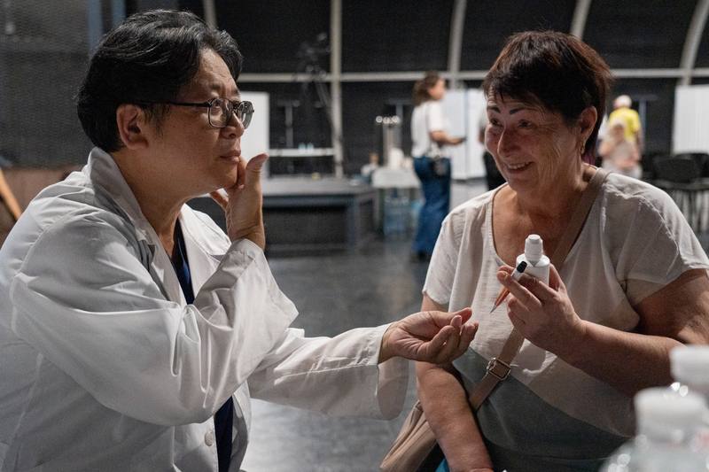 「北美洲台灣人醫師協會」再度前往烏克蘭義診，為基輔民眾與軍人提供醫療服務。在當地的移動診所內，民眾可接受血壓、血糖、尿酸與膽固醇等基本檢查。圖為台灣醫師開藥給患者娜塔莉亞（右）