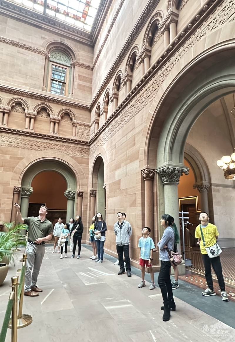 FASCA youth attentively listen to a tour guide explaining the rich history and architecture inside the New York State Capitol.