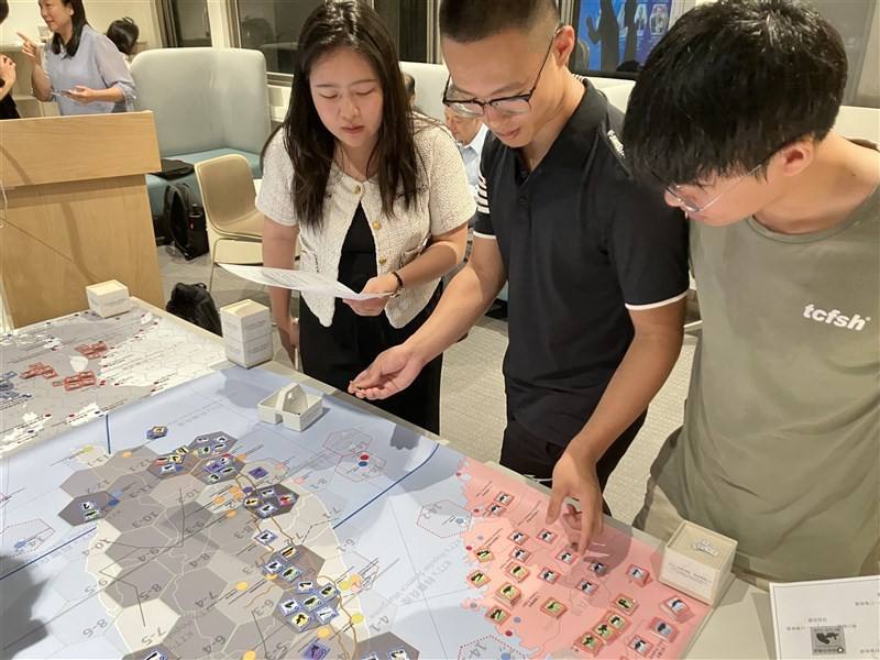 Students participate in a tabletop wargame hosted by the NTU National Security & Strategy Studies Institution in Taipei on Tuesday night. CNA photo Sept. 9, 2025