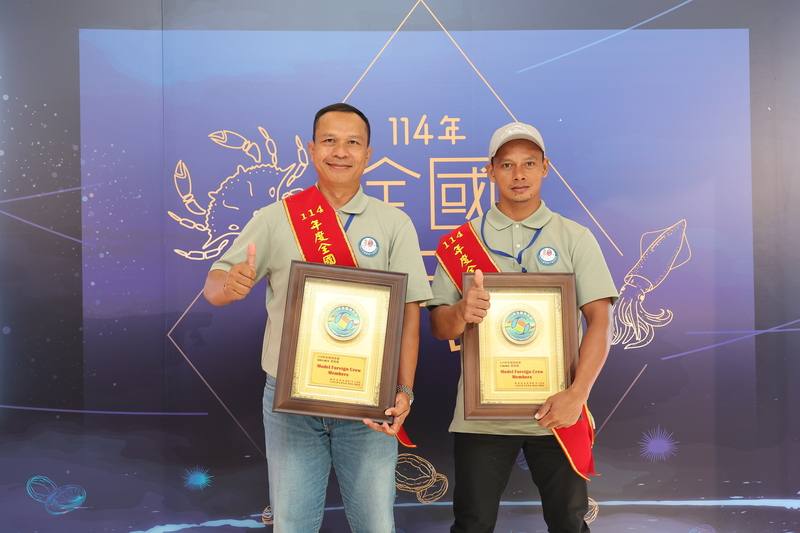 Two Indonesian fishing workers, Soli Hun (left) and Cakida (right), celebrate receiving the ‘Model Foreign Crew Members’ award in New Taipei on Friday. CNA photo Sept. 12, 2025