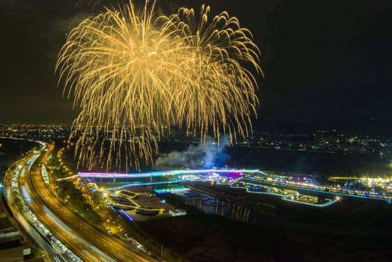 114年國慶焰火將在南投縣會展中心登場，南投縣政府13日指出，今年國慶焰火以南投自然景觀為背景，臨近貓羅溪與情人橋，藉由天際與河岸交織的獨特場域，呈現專屬於南投的國慶印記，16日並將安排約3分鐘的試放。圖為焰火施放模擬示意圖。（南投縣政府提供）