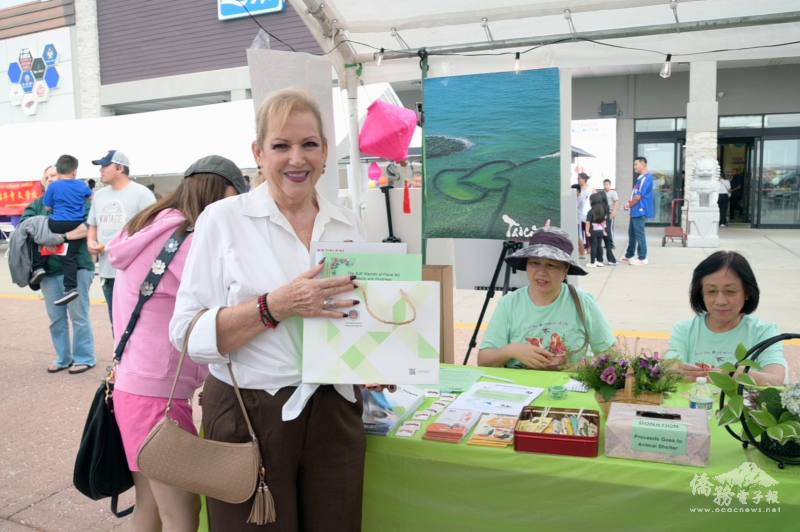 主流人士愉悅地接受臺灣觀光雜誌、美食手冊、愛護動物壓花書籤，以及精美禮物