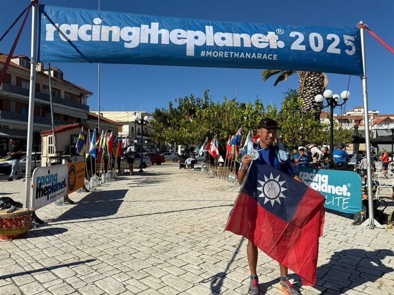 Taiwanese ultramarathon runner Tommy Chen holds up his silver medal with a Republic of China (ROC, Taiwan) flag at RacingThePlanet: Greece. Photo courtesy of Tommy Chen Oct. 5, 2025