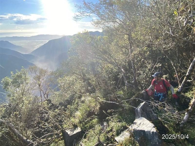 A member of a survey team to Hualien County's Matai'an Creek barrier lake scales a mountain terrain during the mission. Photo courtesy of the Hualien branch of Taiwan's Forestry and Nature Conservation Agency