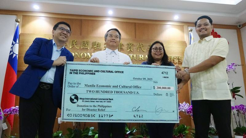 Taiwan's representative to the Philippines, Wallace Chow (left), representing the Taiwanese government, donates US$200,000 to the Philippines. The donation was received by Cherbett Maralit, deputy resident representative of the Manila Economic and Cultura