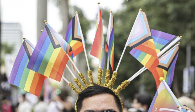 圖為第22屆台灣同志遊行，民眾頭戴多面彩虹旗幟走上街頭。（中央社檔案照片）
