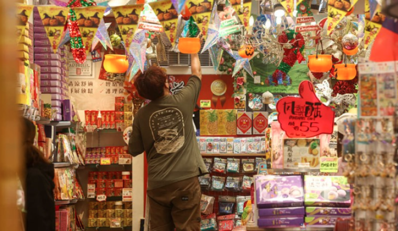 An employee arranging displays inside a shop in Taipei's Ximending shopping district. CNA photo Nov. 10, 2025