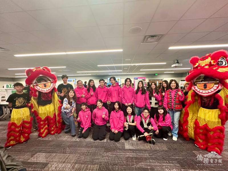 Our amazing volunteers pose together for a photo in front of our table