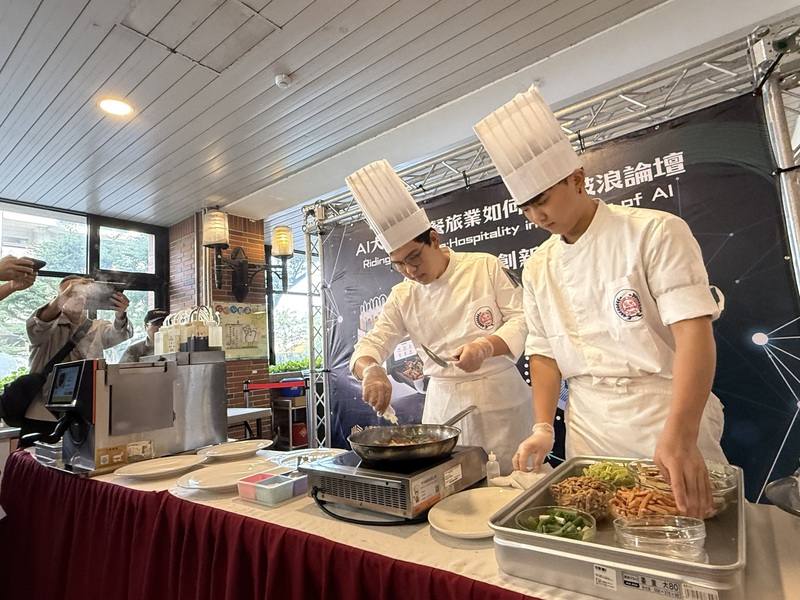 弘光科技大學12日舉辦「AI大浪潮！餐旅業如何乘風破浪」研討會，由真人廚師與AI智能廚師比賽客家小炒，餐旅系大二學生花費6分鐘完成菜品