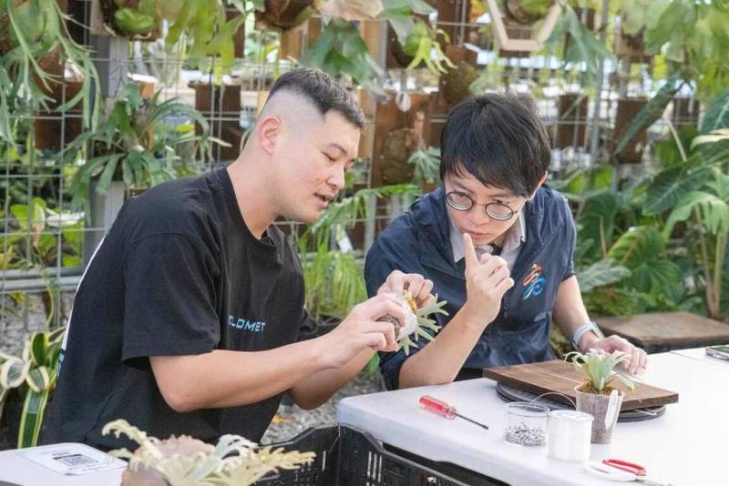 高雄青創品牌「阿金的便秘花園」位於湖內區，青年局長林楷軒（右）近日走訪園區，品牌創辦人宋致穎（左）說明植物特色與園區經營概念。（高雄市青年局提供）