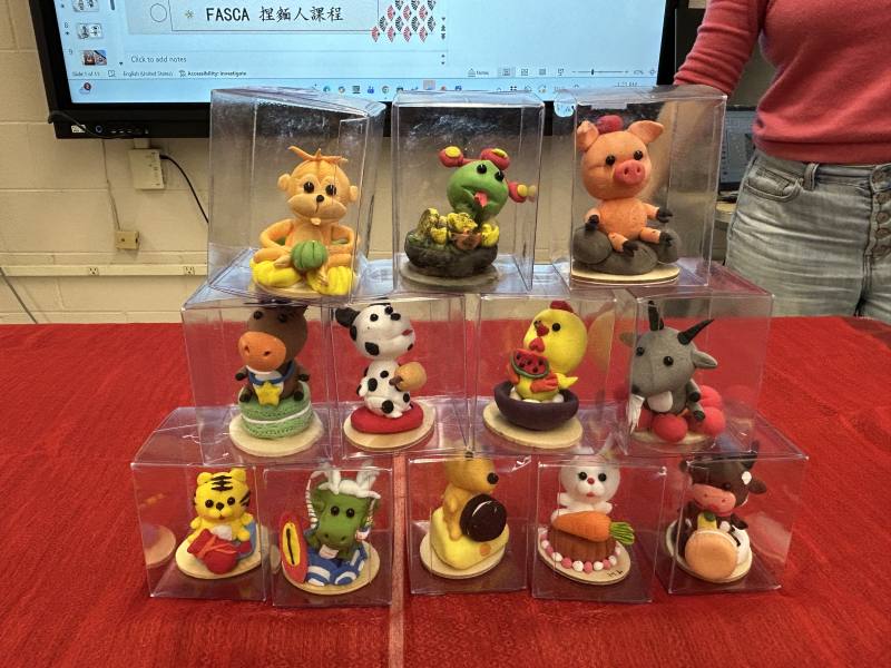 Ms. Lin displays edible dough figurines she crafted in Taiwan, including Lunar Zodiac animals, offering students an authentic glimpse into this traditional folk art.