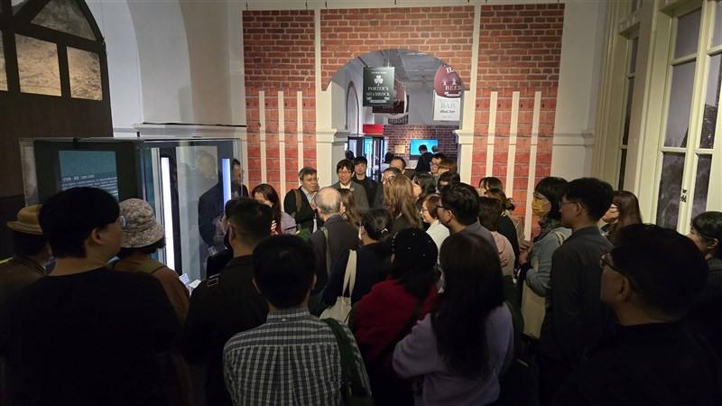 Visitors gather around an exhibition piece at the "Love Loves to Love Ireland: Extremely Distant and Incredibly Close" exhibition, held Friday at the National Museum of Taiwan Literature in Tainan. CNA photo Dec. 19, 2025