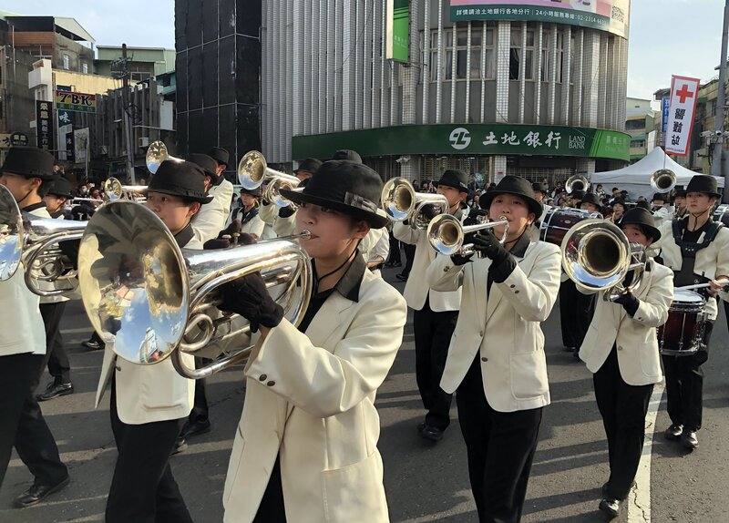 Dressed to a tee, students from Japan's Kumamoto Technical High School Wind Orchestra march down Zhongshan Road in Chiayi City on Saturday. CNA photo Dec. 20, 2025