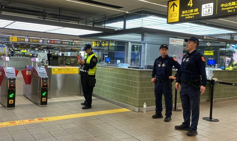 Police officers stand guard inside MRT Zhongshan station on Saturday. CNA photo Dec. 20, 2025