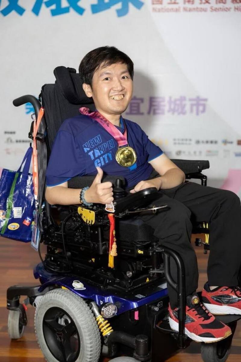 八里愛心教養院生張孜維（圖）自幼罹患肌肉萎縮症，但他不僅完成大學學業，目前正就讀國立體育大學體育研究所博士班，還多次代表台灣參加亞洲及世界帕運地板滾球賽事，為台灣爭光，榮獲全國身心障礙楷模「金鷹獎」肯定。（新北市社會局提供）