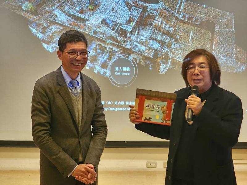 點雲科技重現六堆風華，文化部文化資產局文化資產保存研究中心主任陳柏欽（右）致贈代表傳統建築之書籍給客委會客發中心主任何金樑（左）