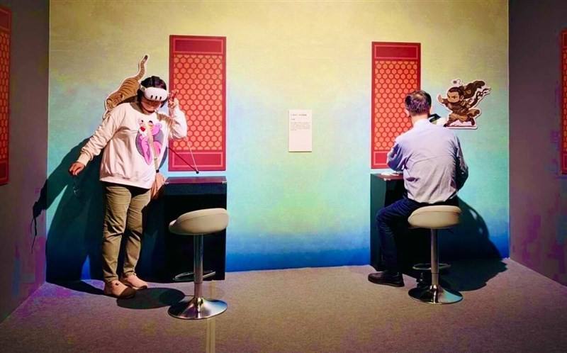 Two attendees of the "Three Taoist Officials" digital art exhibition experience the show in VR in this undated photo. Photo courtesy of the National Palace Museum