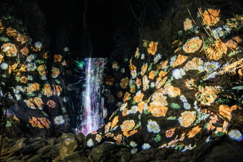 屏東縣高樹鄉「奇幻大津」活動焦點瀑布投影展演，透過多段循環影像呈現萬物共生與能量流動意象，讓瀑布在夜晚展現有別於白日的風貌。（屏東縣政府文化處提供）