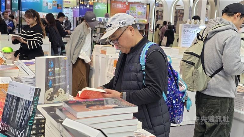 A man reads at one of the stands at the Taipei International Book Exhibition on Tuesday. CNA photo Feb. 3, 2026