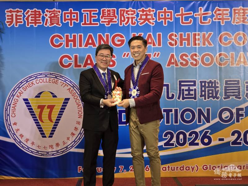 陳立人（左）頒贈現金紅包予模彩活動頭獎幸運兒校長葉啟明（右）