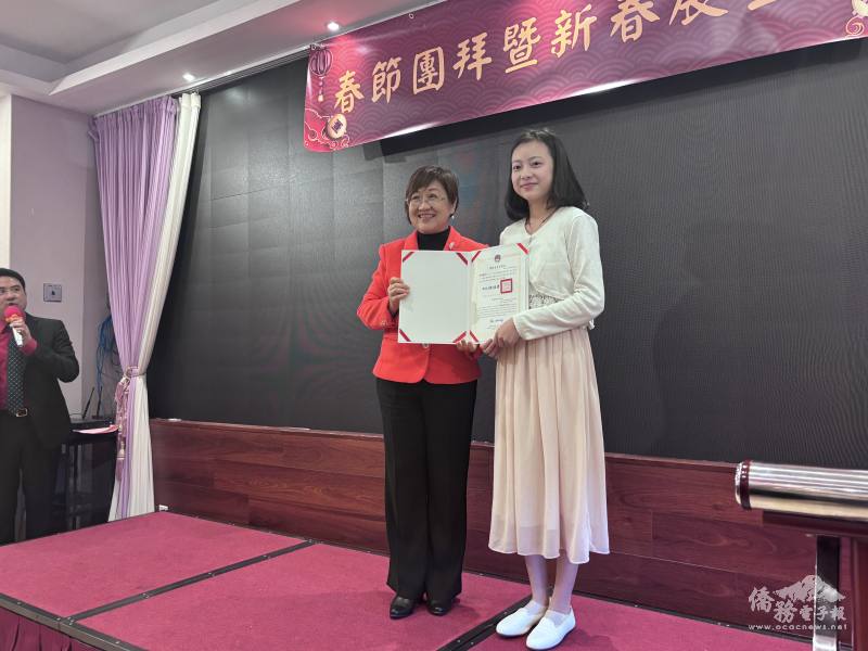 徐佳青(左)頒獎給僑生歌唱比賽得獎學生郭帷然