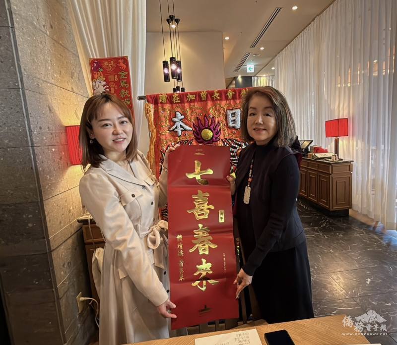 駐日代表處僑務組副組長李承芸（左）致贈總統府春聯予會長曾鳳蘭（右）