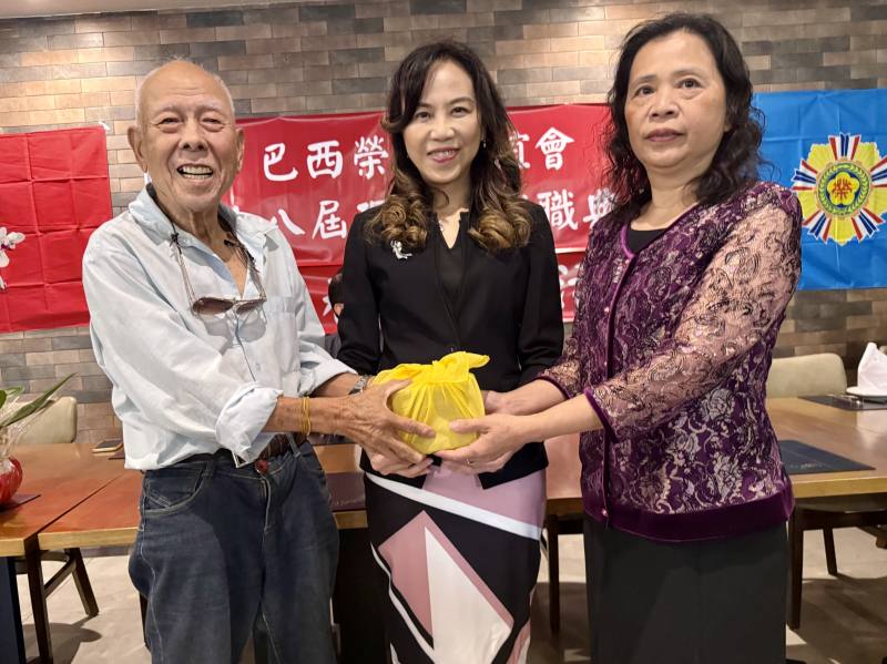 處長朱怡靜（中）監交下，第17屆副會長羅鈞武（左）把印信交給第18屆會長高妮娜（右）