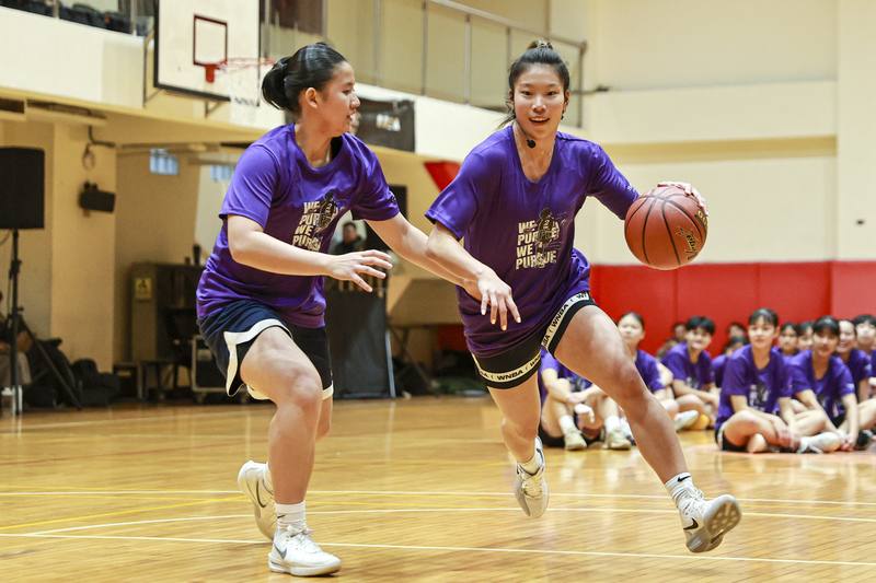 Taiwanese-American WNBA player Kaitlyn Chen (right) plays against a local player during her inaugural basketball camp in Taipei on Tuesday. CNA photo March 10, 2026