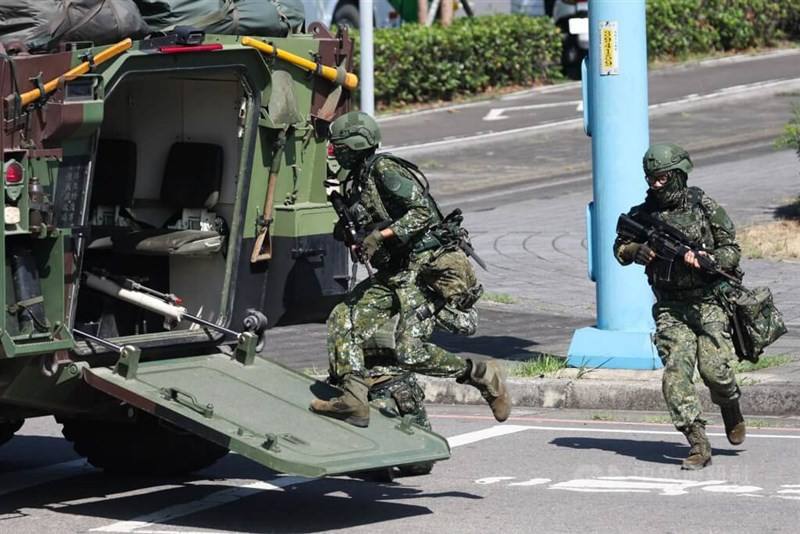 Taiwanese soldiers board an armored vehicle during the 2025 Han Kuang military exercises.